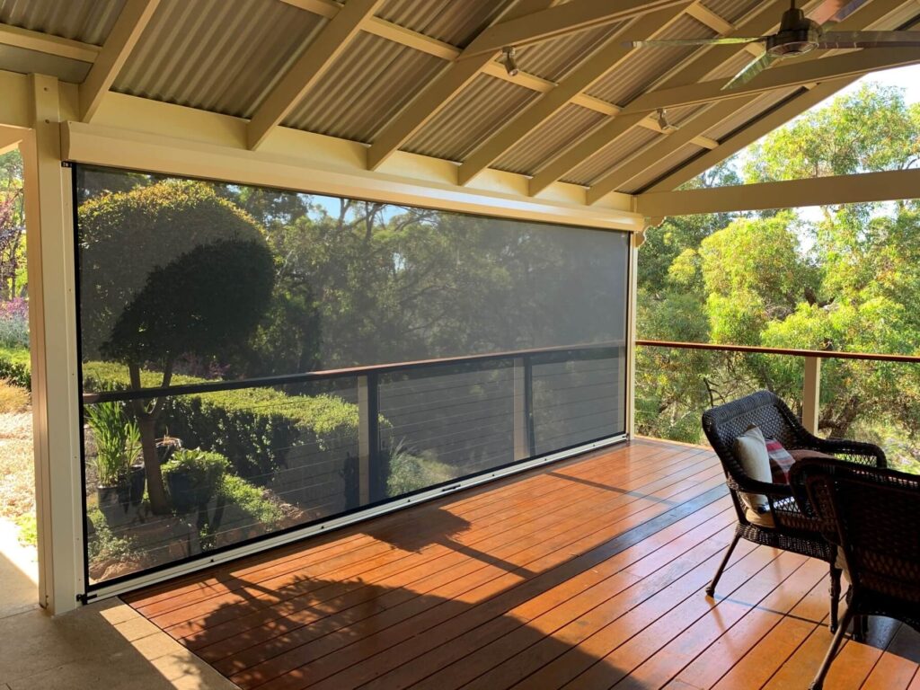 Ziptrak outdoor blind on a timber deck patio overlooking a garden in Roleystone