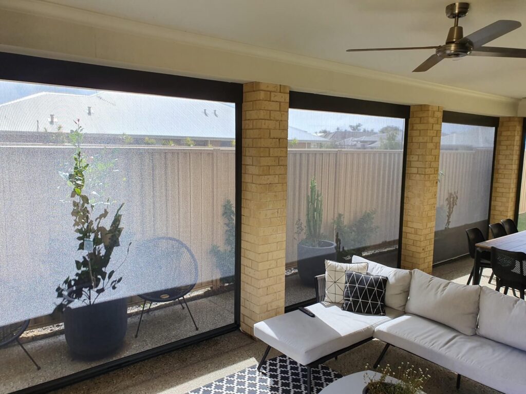 Ziptrak outdoor blinds enclosing a modern alfresco area with brick pillars