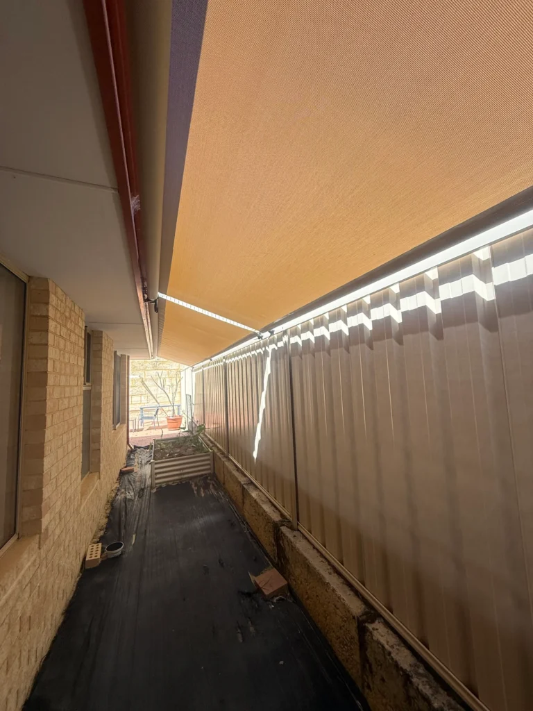 Long side passage in Landsdale shaded by a roof to fence blind