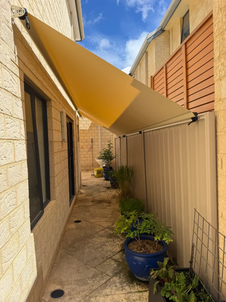 Roof to fence blind shading a narrow side passage at a Salter Point townhouse