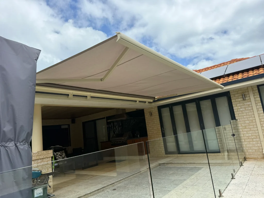 Motorised Siena full cassette folding arm awning extended over a pool terrace in Hillarys