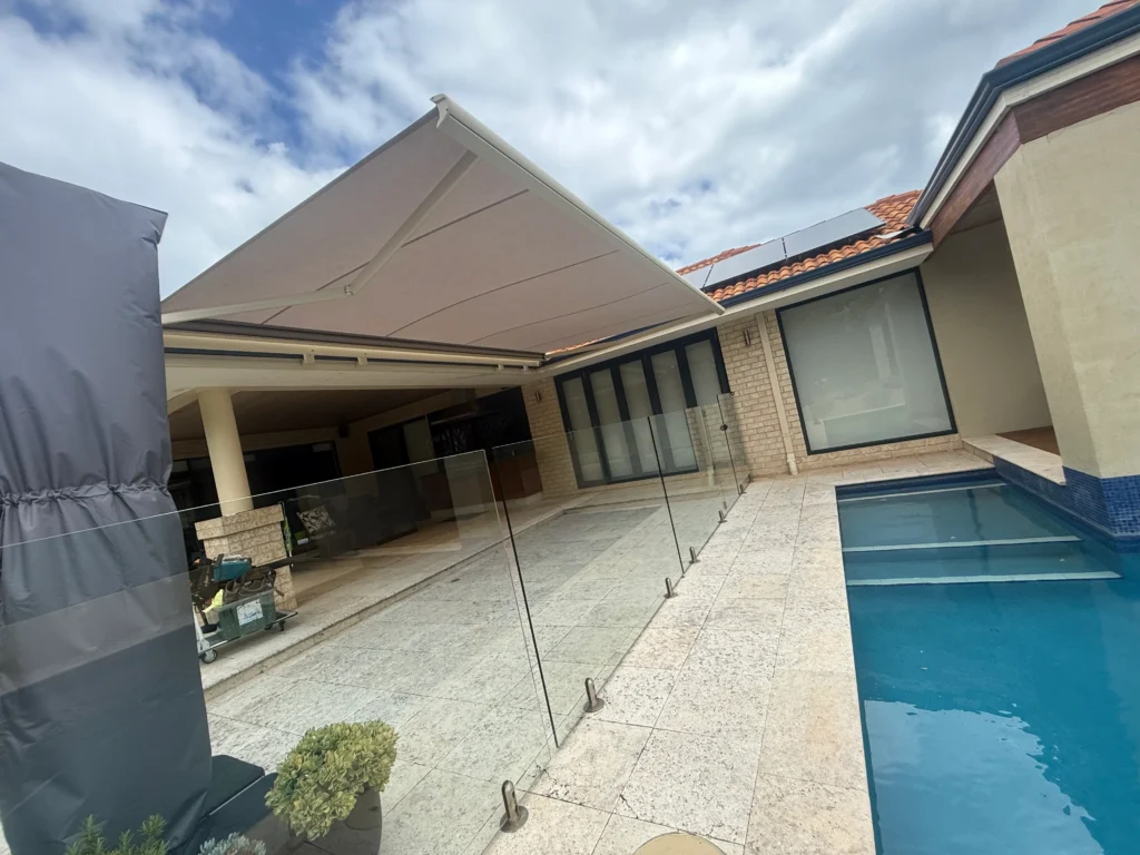 Siena folding arm awning shading the terrace beside a lap pool in Hillarys