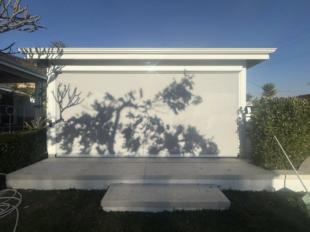 White garden pavilion in Beaconsfield closed off with a wide Ziptrak outdoor blind