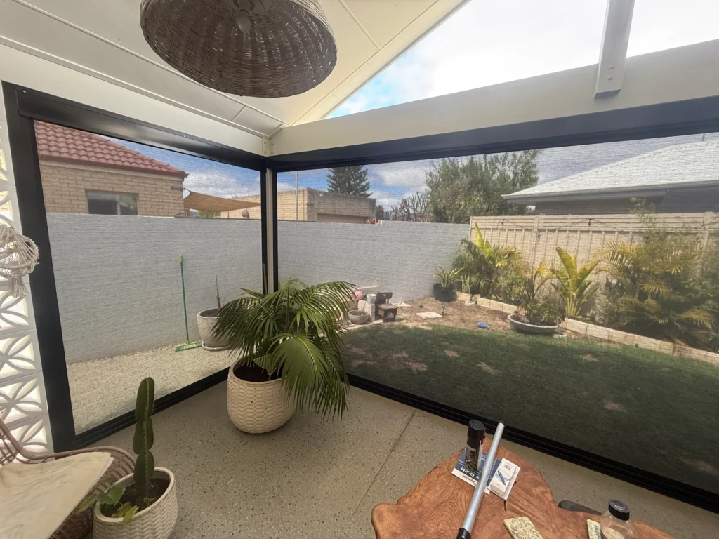 Ebony Ziptrak outdoor blinds enclosing a gable roof alfresco in Safety Bay, viewed from inside