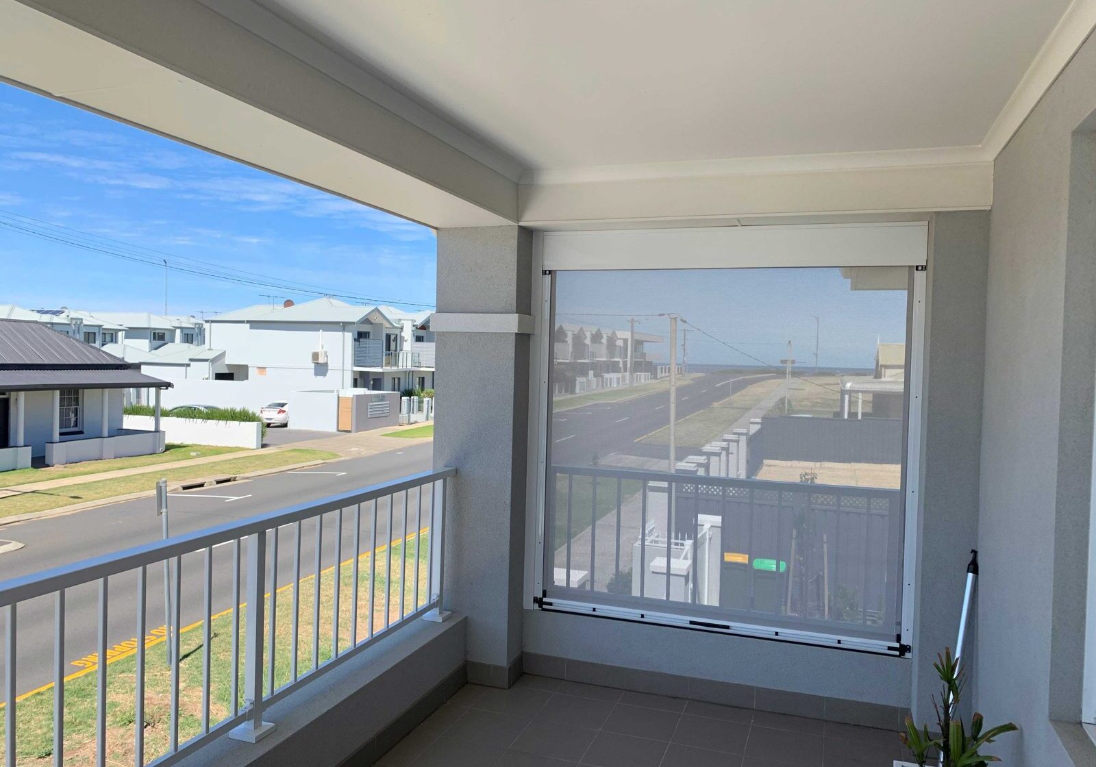 Balcony blind shading a coastal balcony while keeping the outlook