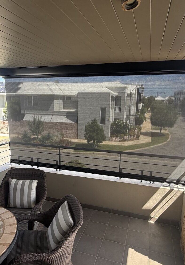 Alfresco balcony with a cable guided blind creating a sheltered outdoor living area