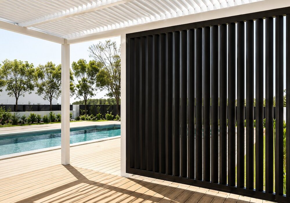 Black vertical aluminium shutters screening a poolside alfresco
