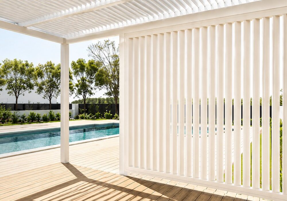 Cream vertical aluminium shutters beside a pool